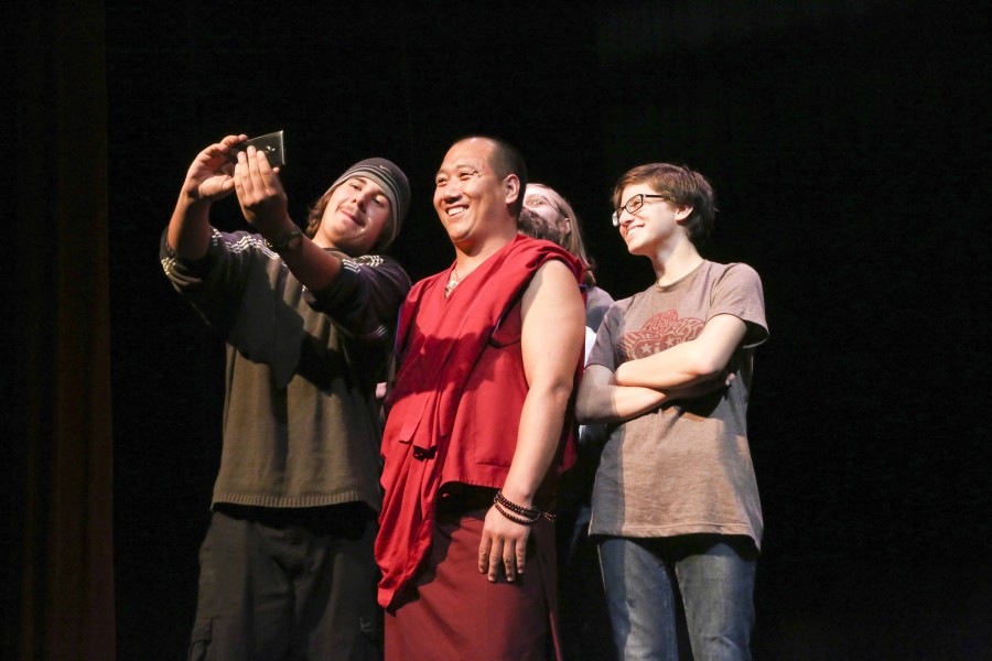 Students take a selfie with one of the monks.