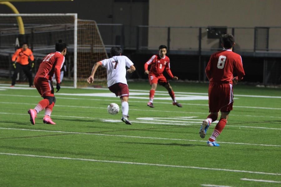 Senior co-captain Martin Medina controls the ball and heads towards the opposing teams goal during their varsity game against Del Valle. 