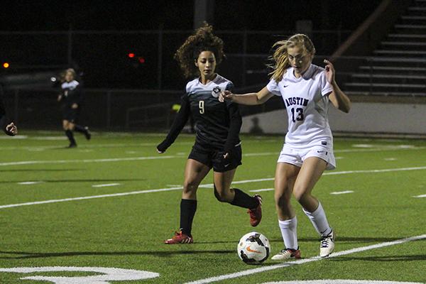 Sophomore Gracie Jackson dribbles the ball down the field during the varsity game against Lanier. 