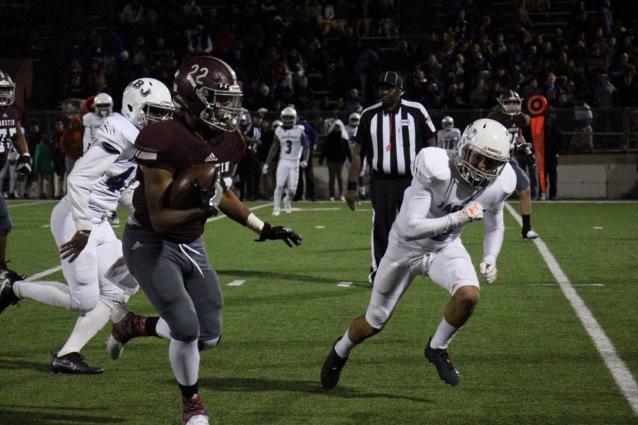 Running Back Romeo Brown runs the ball in hopes for a first down. 