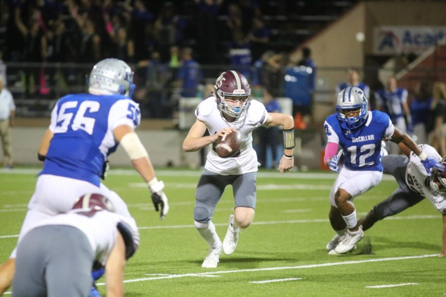 Freshman quarterback Charles Wright rushes through the line of scrimmage at the varsity football game against McCallum at House Park on Oct. 5.