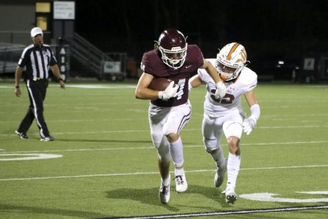 Senior Colby Kalbacher runs with the ball in the game against Connally.