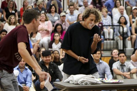 Senior Djavan Ploetz-Aponte competes in the whip cream bubble gum challenge at the first pep rally.