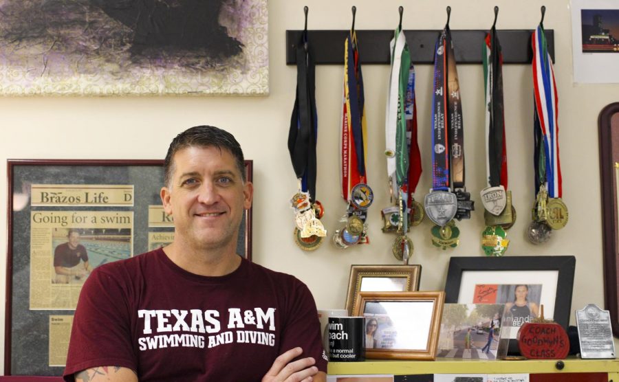 New to the swim team, Ryan Goodwyn shows off his collection of swimming memorabilia.