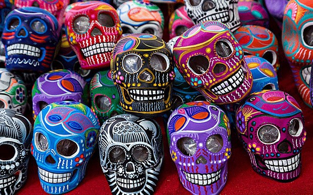 Sugar skulls are made out of actual sugar pressed into a mold and decorated with icing, feathers, and paints
