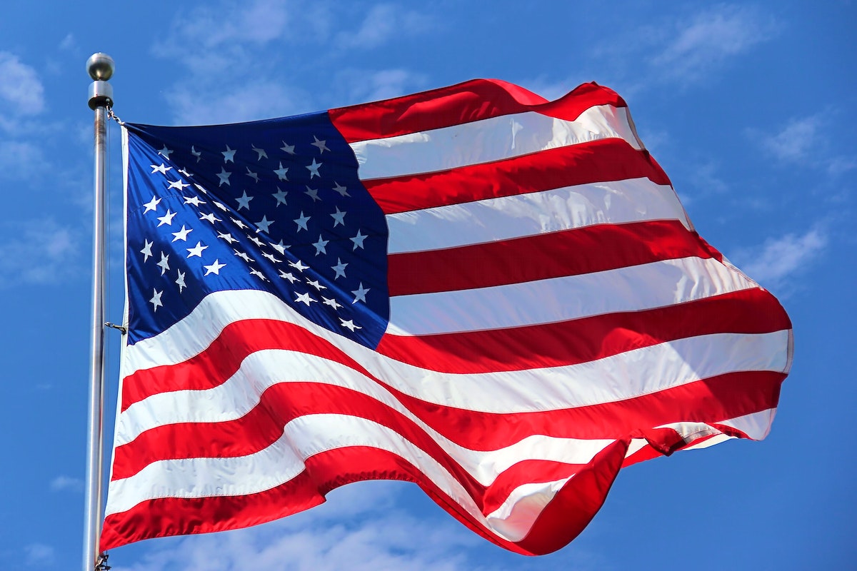 American flag waving against sky. Free public domain CC0 photo.